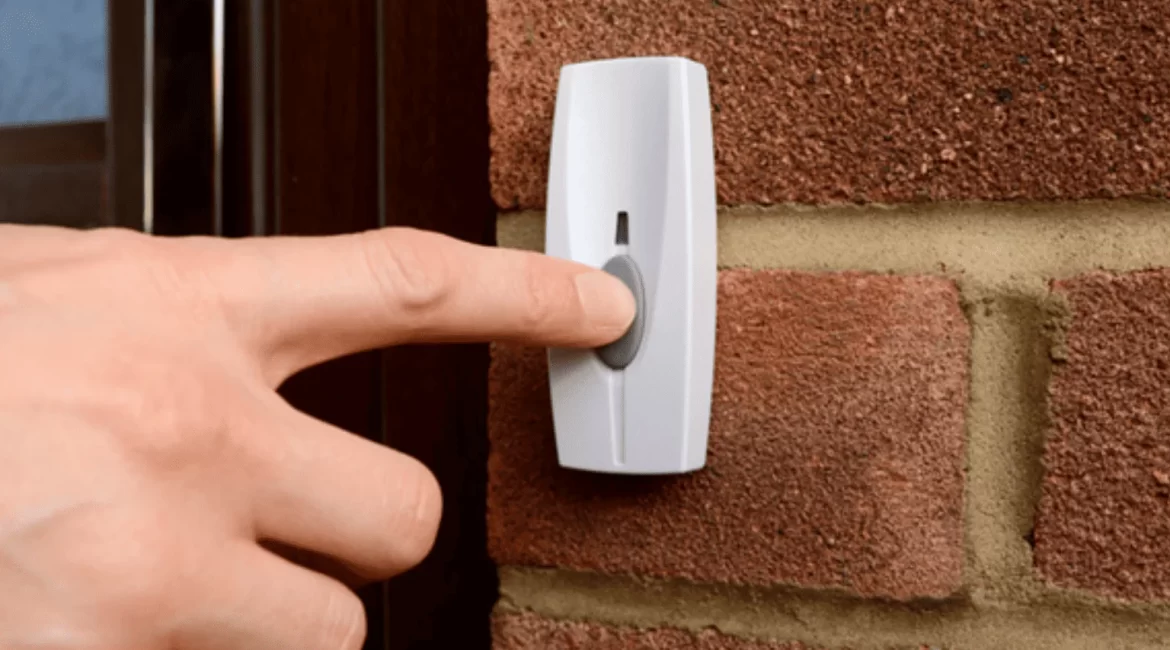 Dedo pressionando a campainha, ilustrando problema de campainha que não funciona